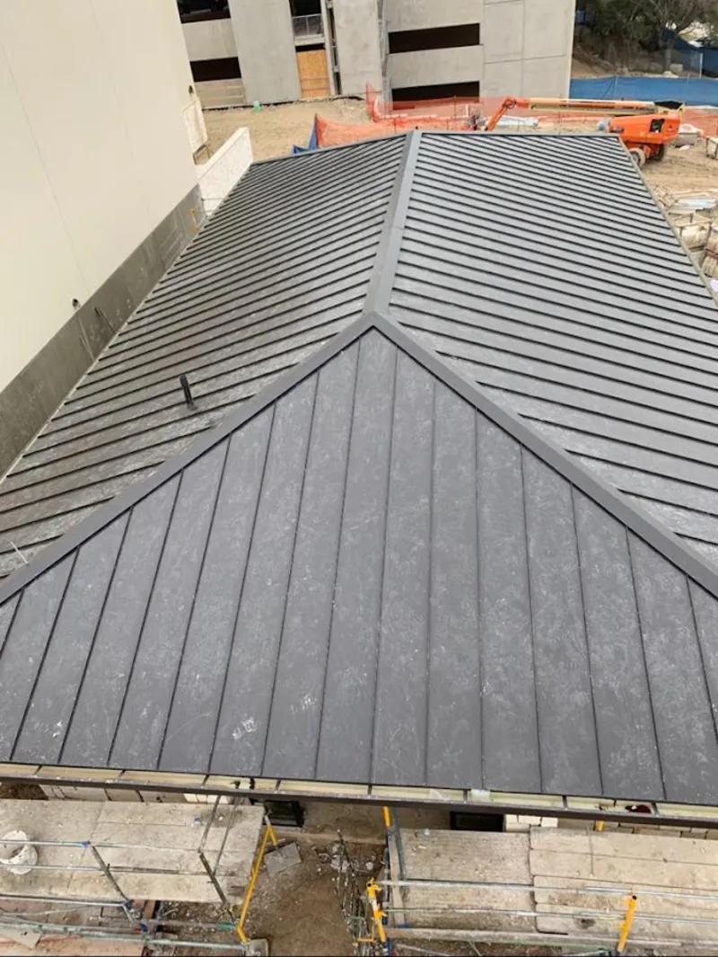 Commercial metal roof construction with crane equipment in Shamokin